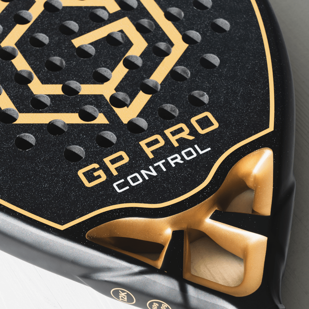 Close-up of the gold GP Pro Control logo and throat on the Golden Padel racket