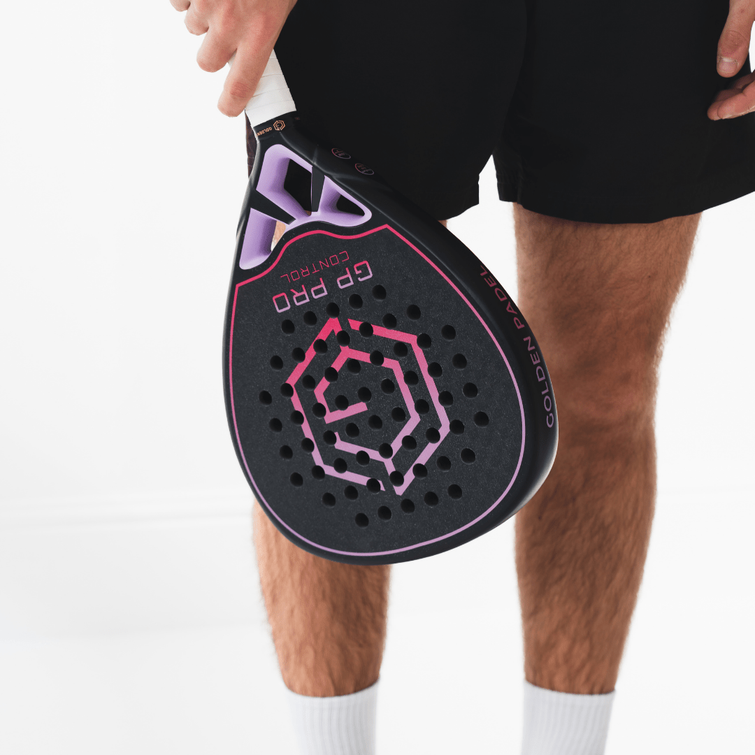 Player holding the black and pink Golden Padel GP Pro Control racket