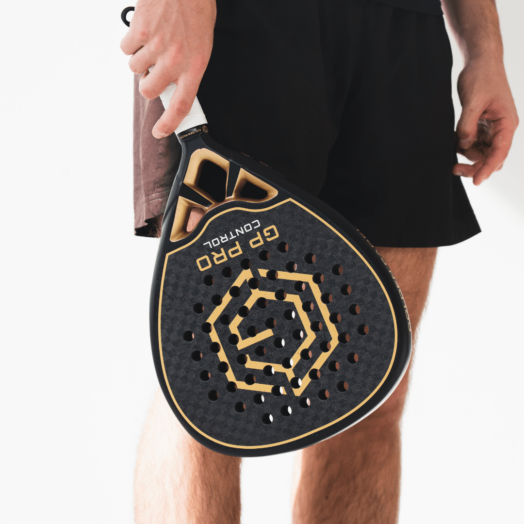 Player holding the black and gold Golden Padel GP Pro Control racket