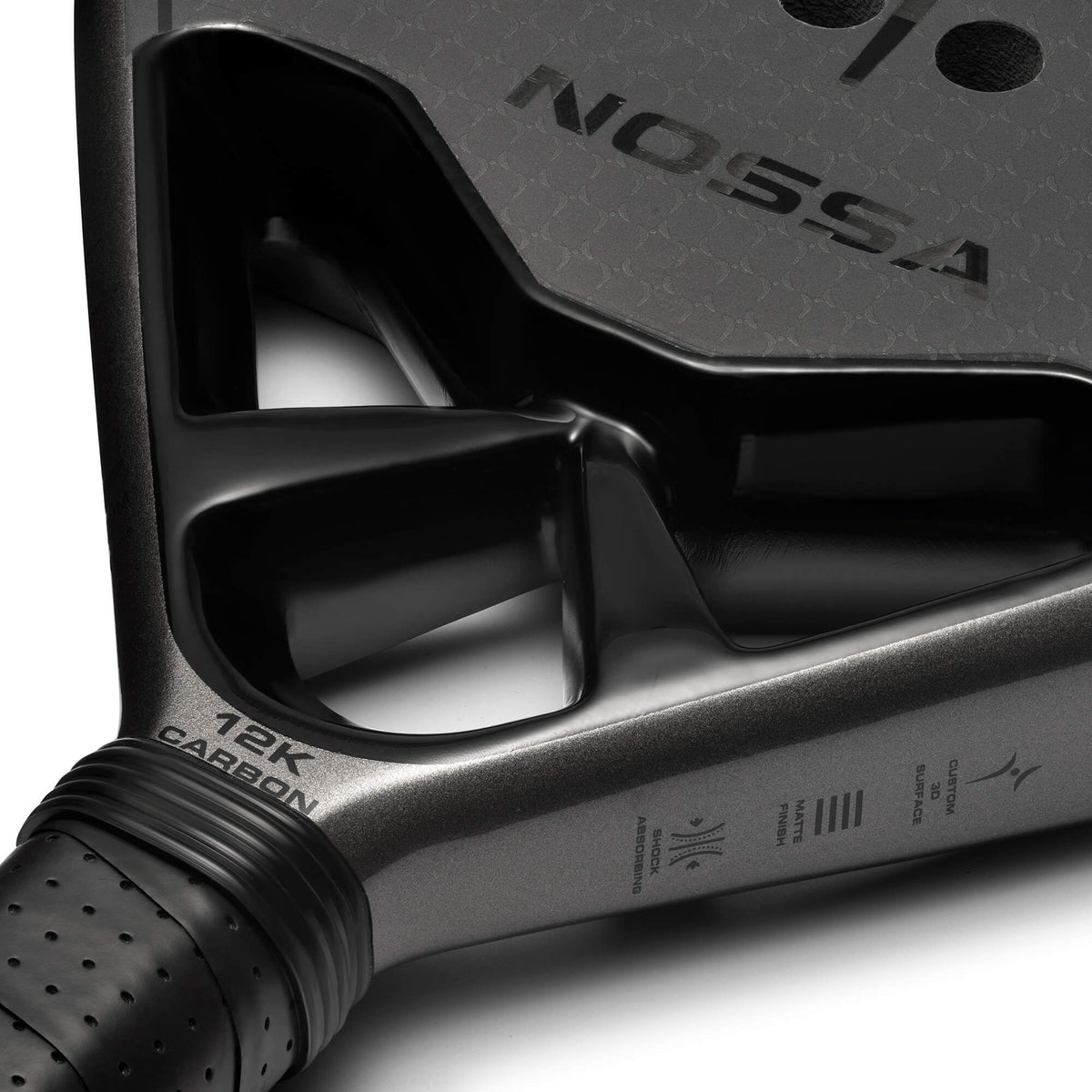Close-up of the black NOSSA Padel CORE racket throat and handle