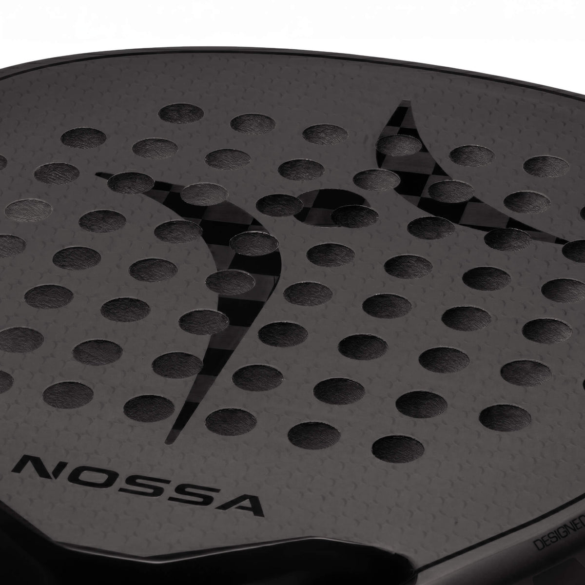 Close-up of the black NOSSA Padel CORE racket face, perforation pattern and logo