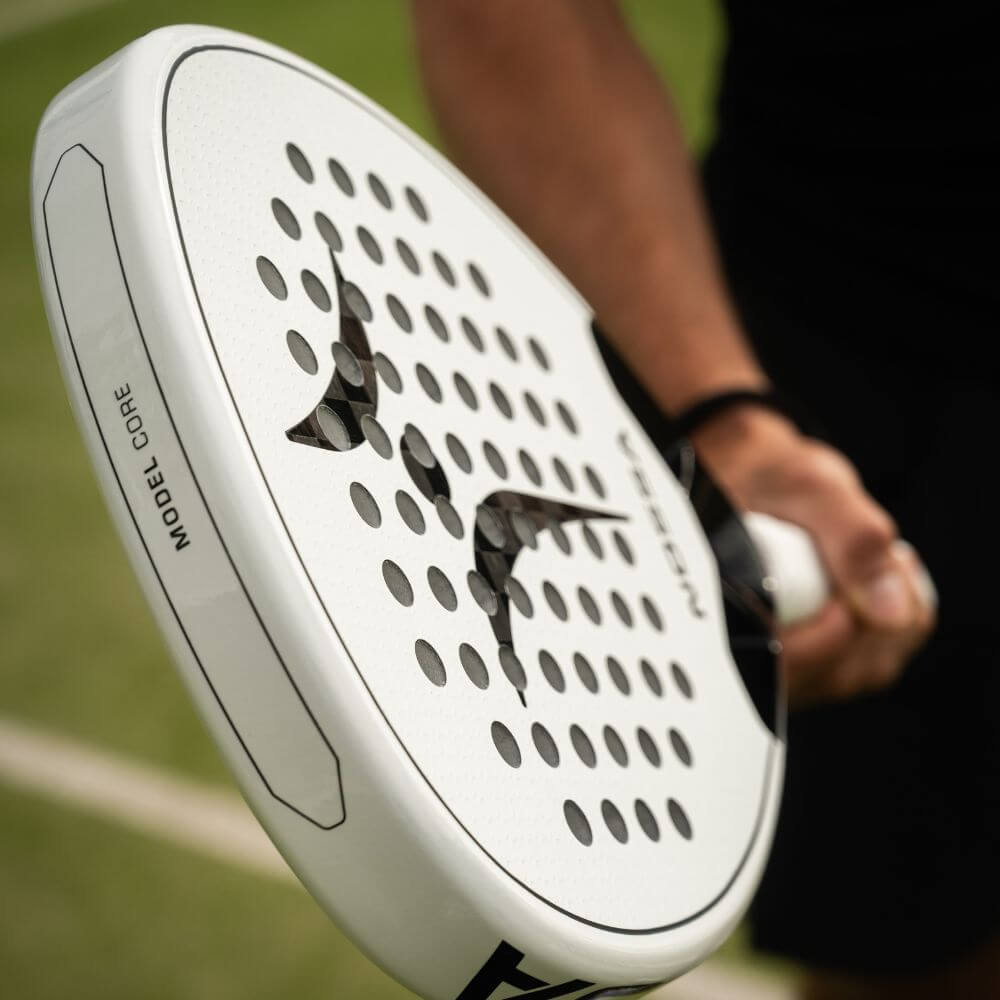 Player holding the white NOSSA Padel CORE racket on court