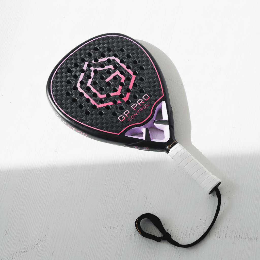 Golden Padel GP Pro Control racket in black and pink with wrist strap, angled view