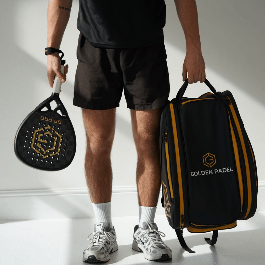 Player with padel racket next to the Golden Padel Pro Tour backpack in black and gold