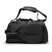 NOSSA Padel HYBRID rucksack in black, carried as a holdall with shoulder strap