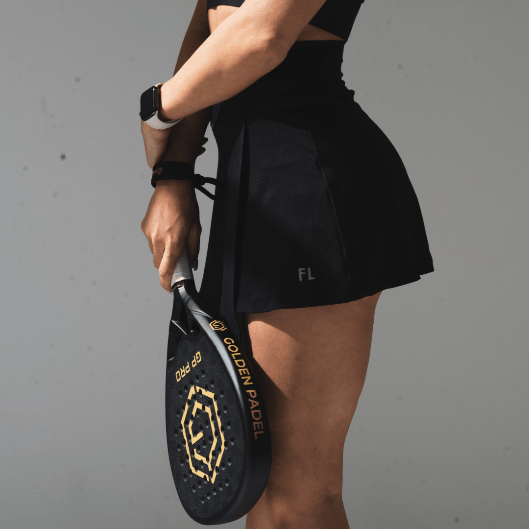Woman holding the Golden Padel GP Pro racket by her side